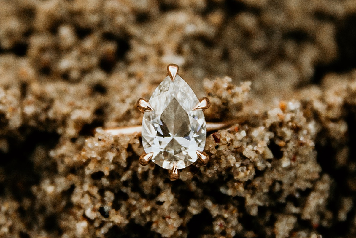 engagement ring in the sand