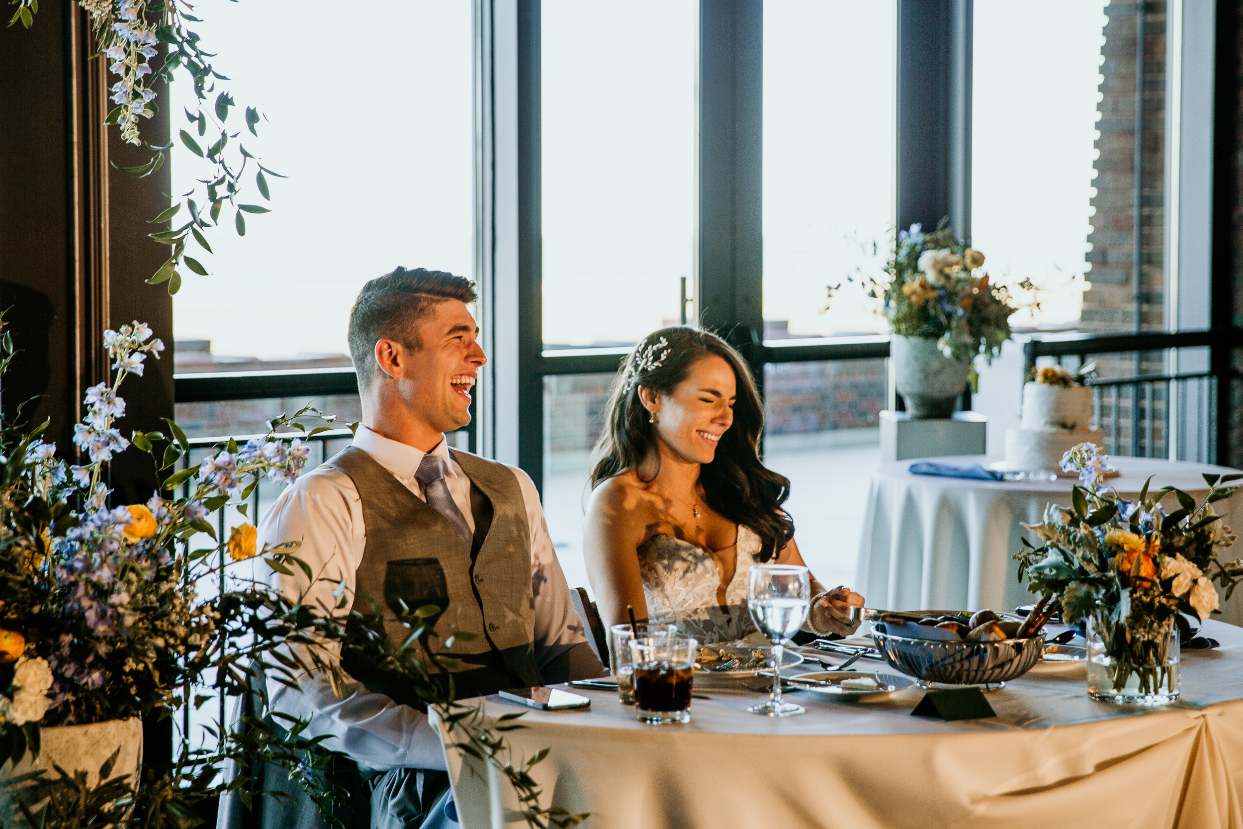 bride and groom laughing during speeches